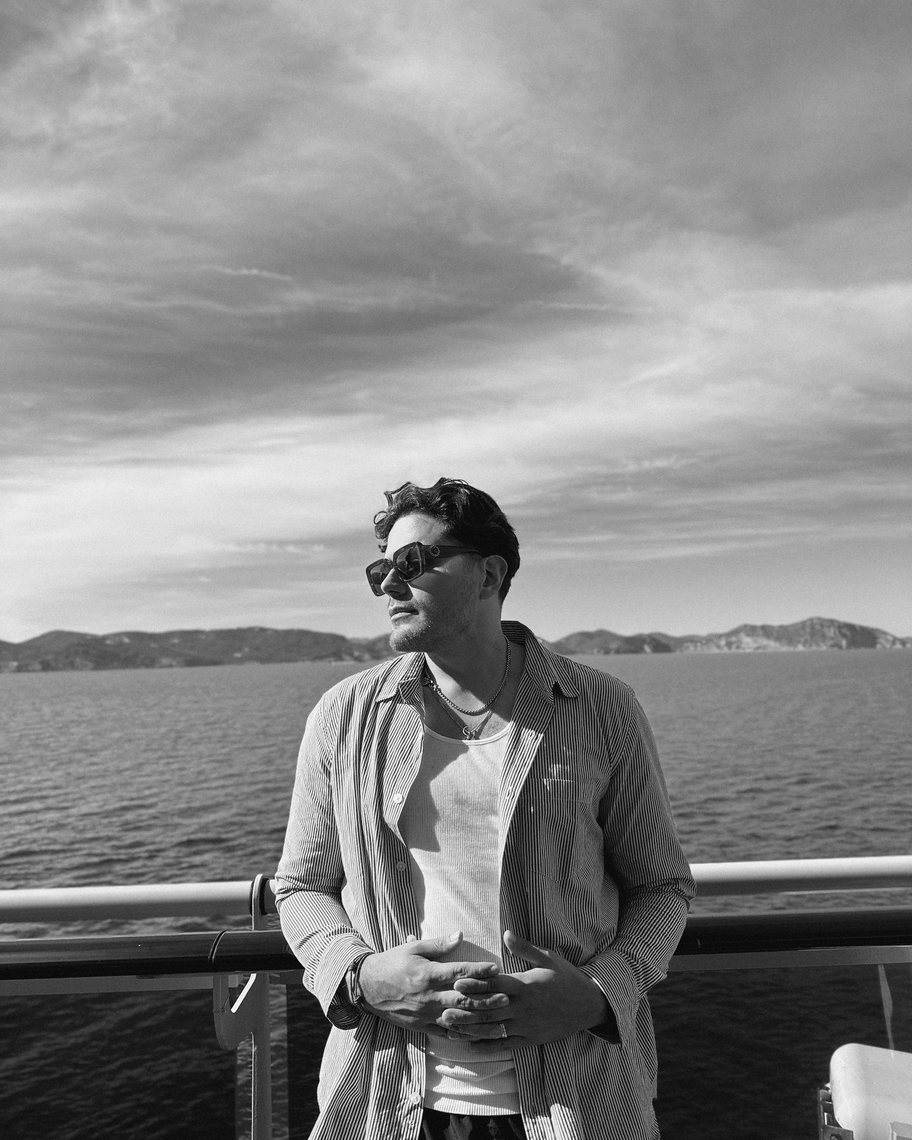 Elvis Suarez on the deck of a ship at sea.