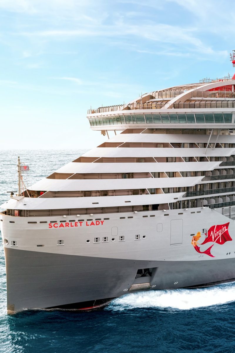 The bow of Scarlet Lady at sea, with the ship's name and Virgin logo on the hull.